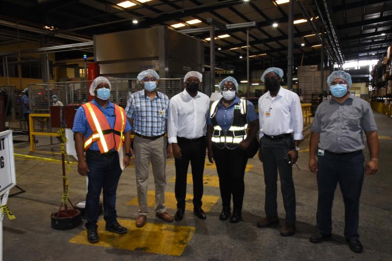 Mr. Abdullah strikes  a pose with Managers of the Banks DIH Limited
